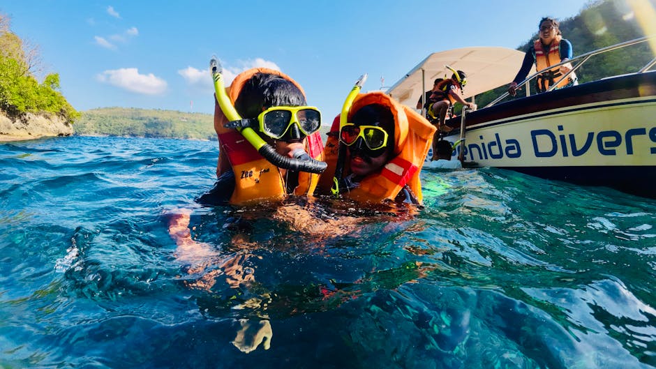 family snorkeling tropical ocean children safety gear clear water reef